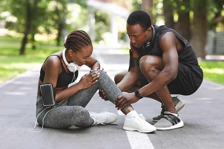 athletic-woman-injured-man-helping