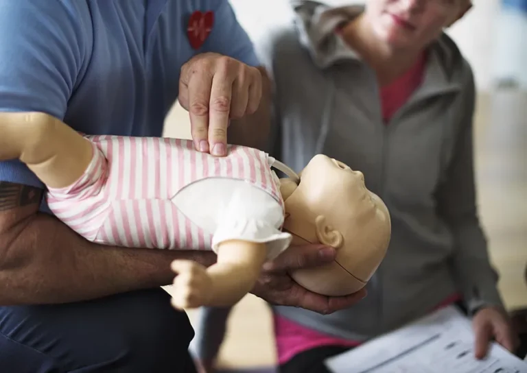 cpr-first-aid-training-on-a-doll-infant