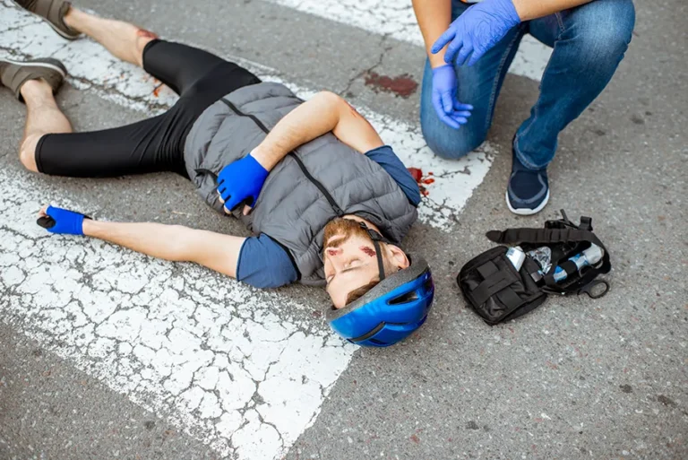 injured-bicyclist-lies-on-crosswalk-after-accident