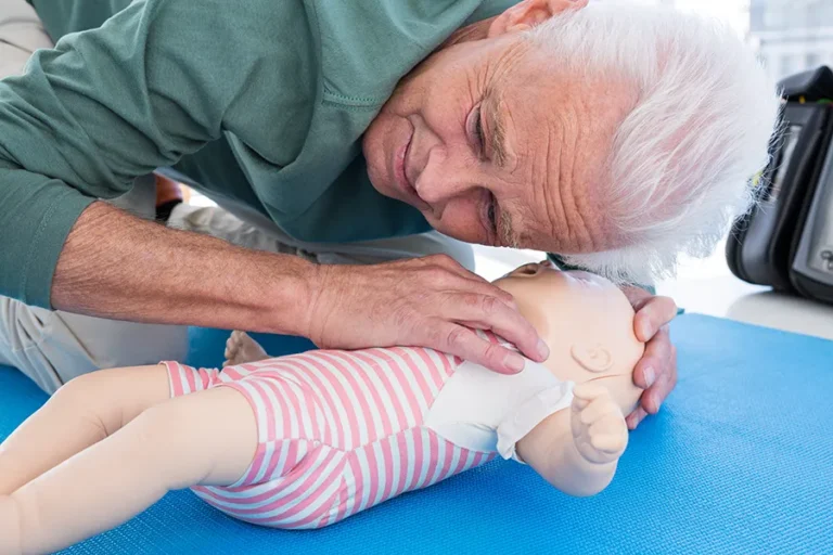 senior-man-practices-cpr-on-a-training-mannequin