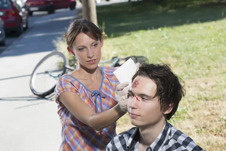 woman-helping-injured-young-man